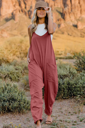 V-neck wide-leg jumpsuit in rust with pockets, a comfortable cotton blend, and a relaxed fit.