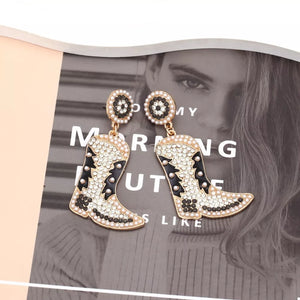 Dazzling cowboy boot earrings with pearls and black and white details.