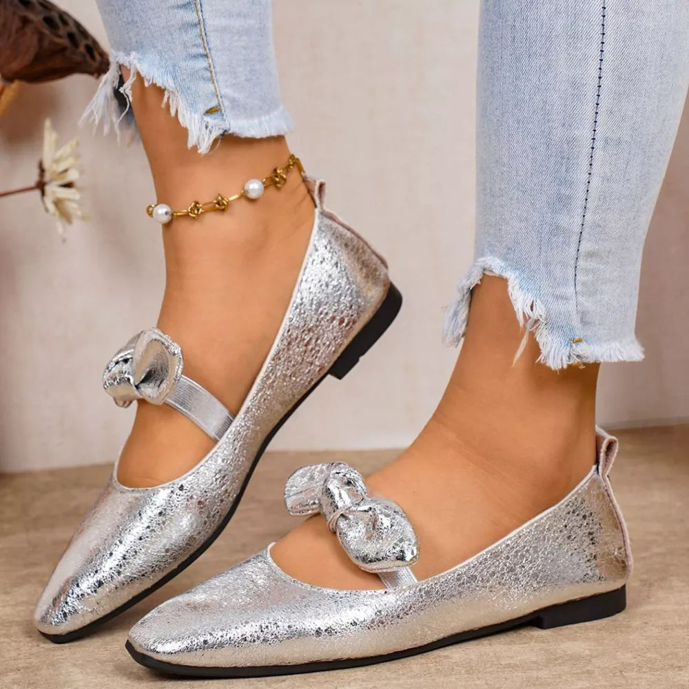 Chic silver slip-on flats with bow detail and square toe.