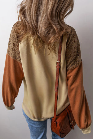 Tan sweatshirt with crochet yoke and contrast sleeves, styled with a brown crossbody bag.