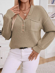 Relaxed knit sweater in tan with button detail, V-neck, and chest pocket.