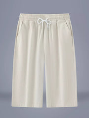 Relaxed ivory cropped sweatpants with drawstring waist and side pockets.