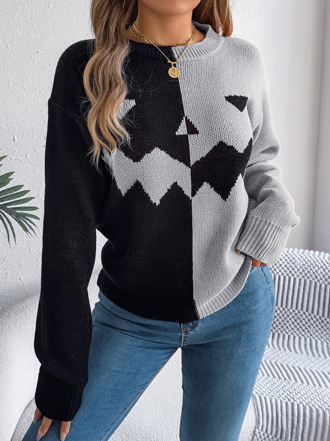 Split-Face Pumpkin Knit Sweater in black and gray acrylic with a crew neck.
