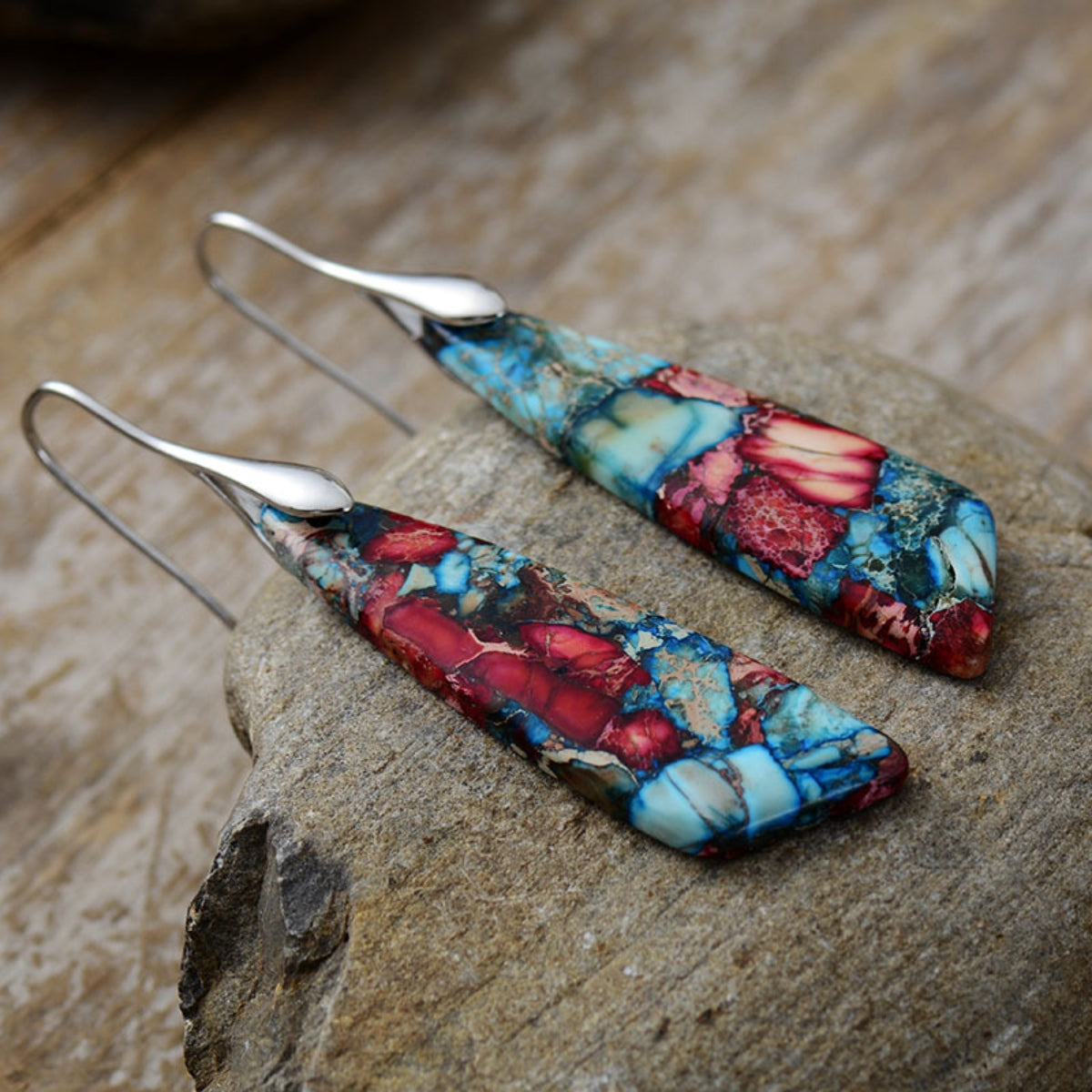 Marbled stone teardrop earrings in red and blue with silver hooks.