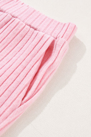 Blush pink ribbed loungewear pants with a pocket detail.