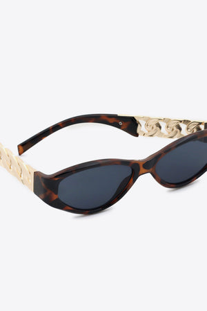Tortoiseshell cat-eye sunglasses with gold chain detail on temples