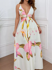 White floral maxi dress with cutout sides, deep V-neck, and decorative ring detail.