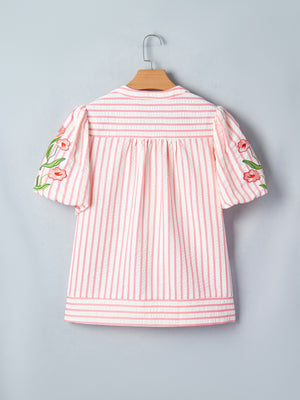 Floral embroidered puff sleeve blouse with pink and white stripes.