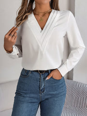 White V-neckline blouse with pleated detail and long sleeves.