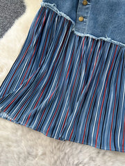 Patchwork denim midi skirt with blue, white, and red striped pleated detail and button front.