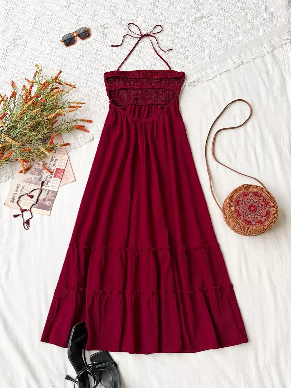 Burgundy halter neck tiered maxi dress with smocked bodice and tie back.