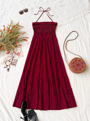 Burgundy halter neck tiered maxi dress with smocked bodice and tie back.