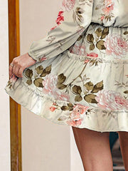 Ivory floral print tiered mini dress with ruffled hem and long sleeves.
