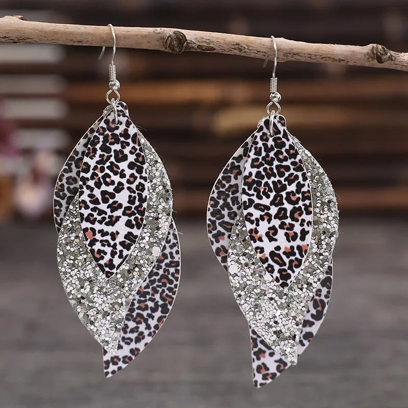 Leopard print layered drop earrings with glitter accents, available in gold and silver.
