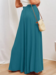 Textured drawstring palazzo trousers in deep teal, with a cinched waist and wide leg.