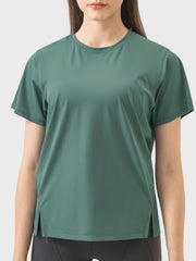 Performance slit hem tee in dark green with short sleeves and crew neck