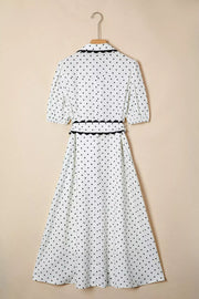 White polka dot midi dress with black trim and tie belt