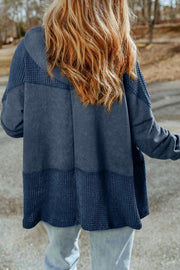 Colorblock knit zip-up hoodie in Peacock Blue with textured panels and a relaxed fit.