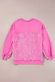 Fuchsia pink sweatshirt with sequin panel detail and crew neck.