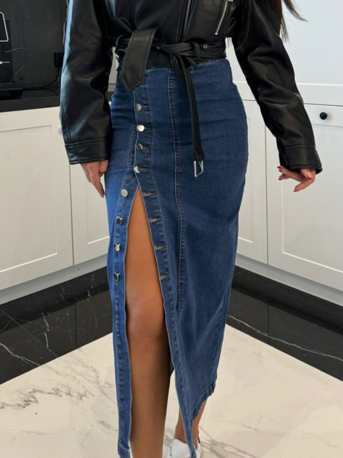 Button-front denim midi skirt in medium wash with a high slit and silver buttons.