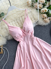 Pink V-neck spaghetti strap mini dress with adjustable straps and a draped bodice.