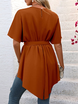 Caramel asymmetrical hemline tie-waist blouse with short sleeves and a keyhole back.