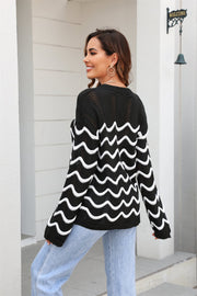 Black wavy knit openwork sweater with white wave pattern and crew neck.