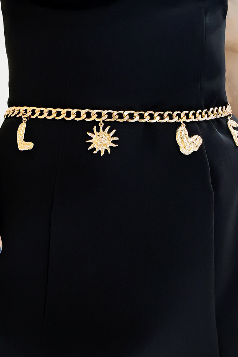 Gold chain belt with celestial charms including sun and heart