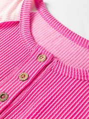 Color block henley t-shirt in fuchsia pink with textured stripes and button detail.