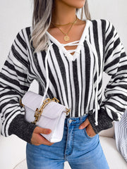 Black and white striped knit pullover sweater with lace-up neckline detail.