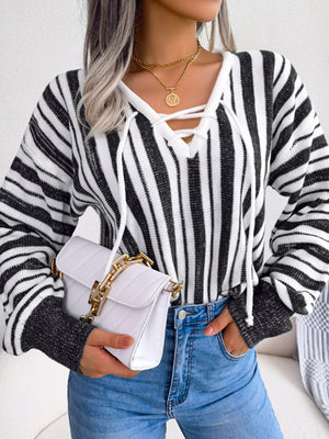 Black and white striped knit pullover sweater with lace-up neckline detail.