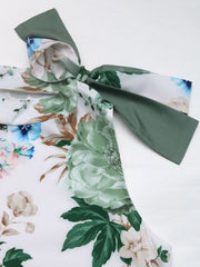 Painterly floral bow-neck sleeveless top in Gum Leaf with a white base and green, blue, and tan flowers.
