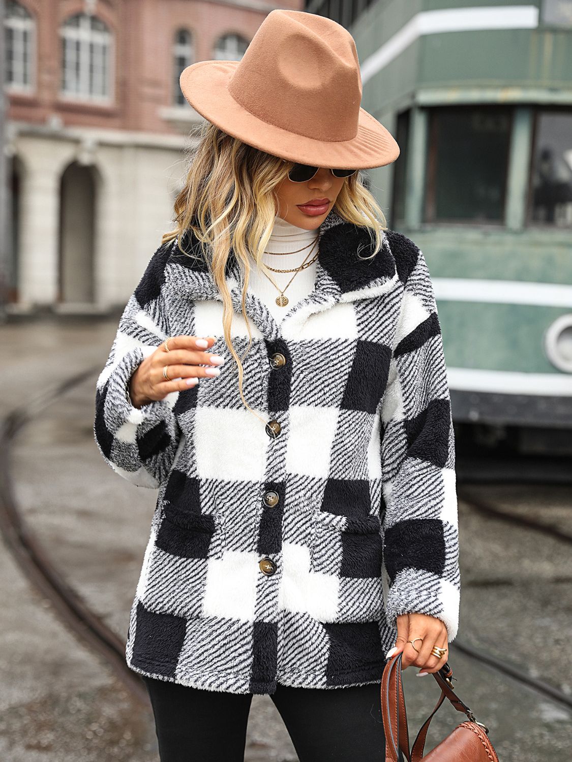 Textured plaid teddy button-up jacket in black and white with button details and pockets.