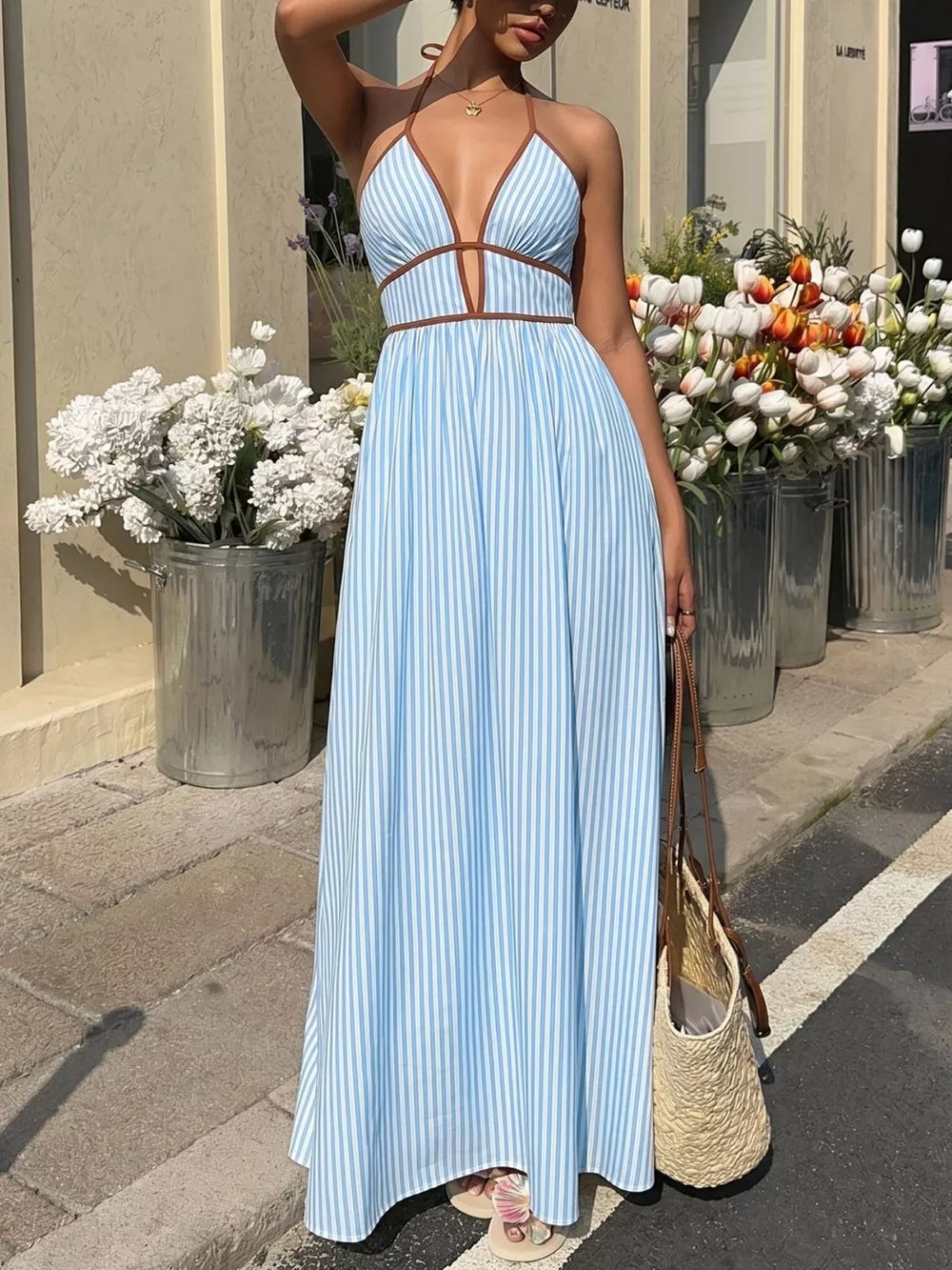 Blue striped halter maxi dress with brown trim and a-line skirt.