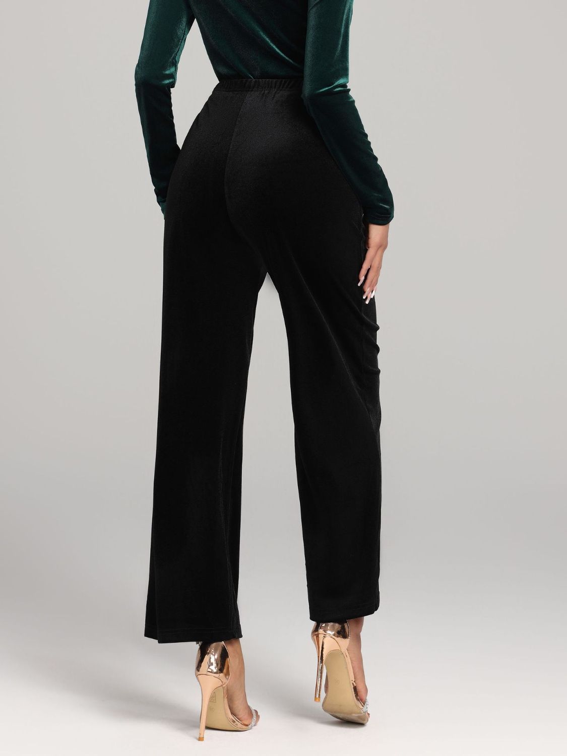 Black velvet palazzo trousers with a wide leg cut and elastic waistband.