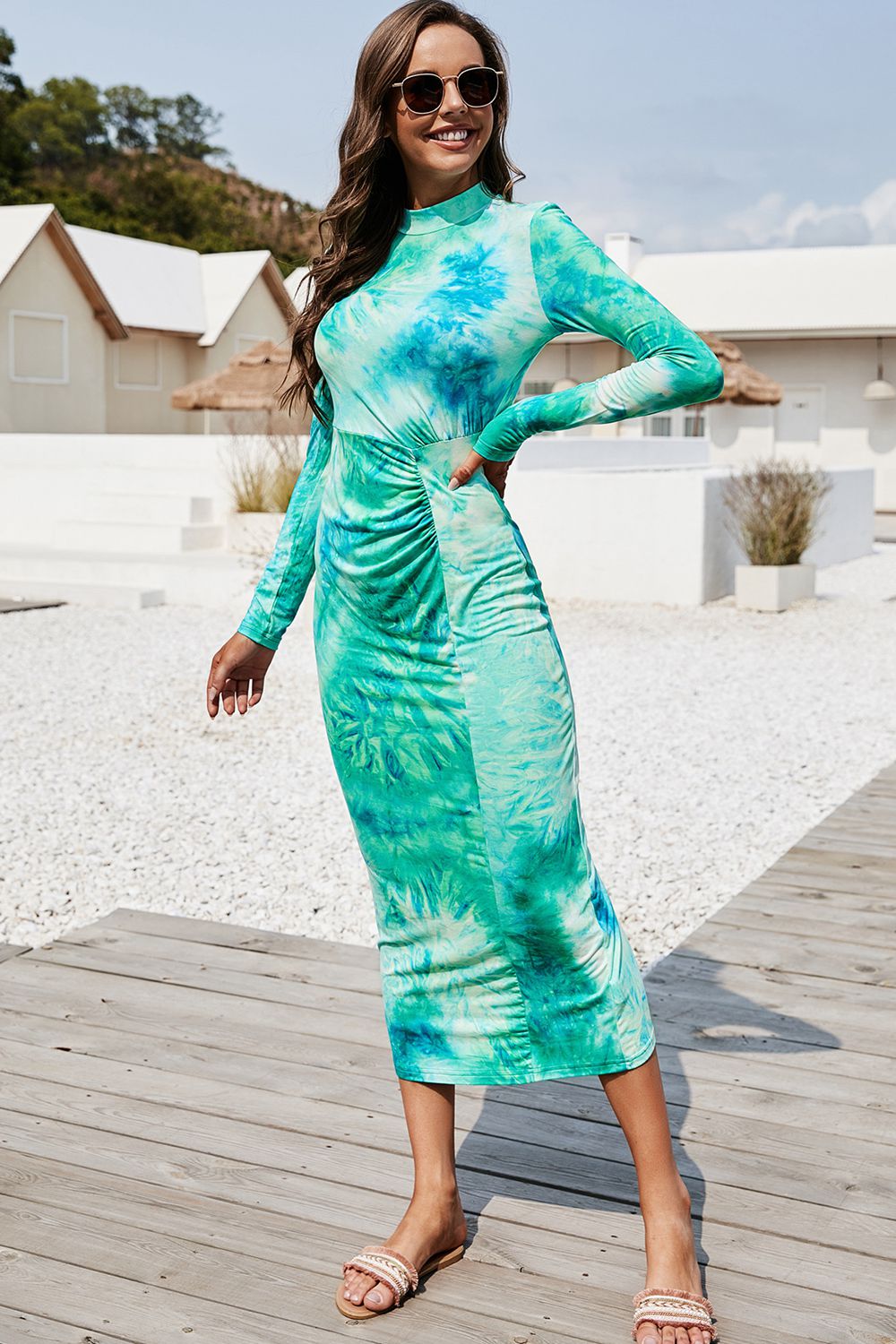 Turquoise tie-dye ruched midi dress with mock neck and long sleeves.