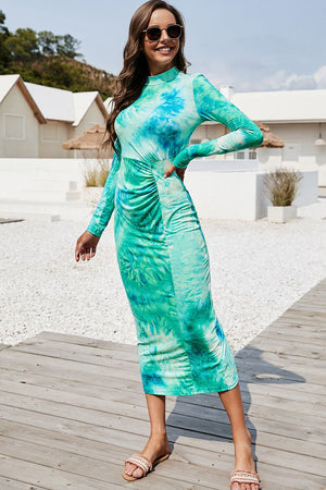 Turquoise tie-dye ruched midi dress with mock neck and long sleeves.