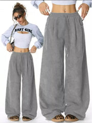 Gray corduroy maternity wide-leg trousers with drawstring waist and pockets.