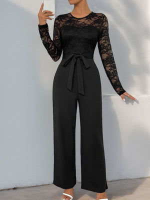 Black lace bodice wide-leg jumpsuit with long sleeves and a tie waist.