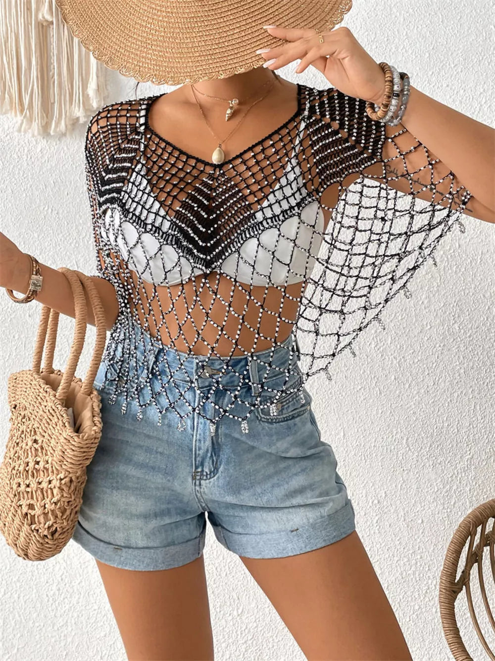 Black crochet cardigan with beaded details and V-neck, perfect for layering.