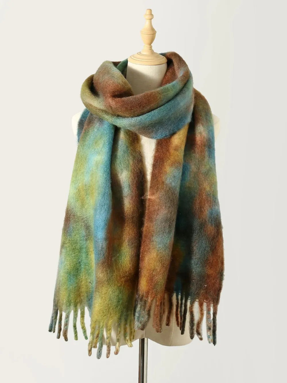 Watercolor wash fringe scarf in multicolor with brown, blue, and green hues.