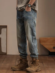 Relaxed fit vintage wash denim jeans with unique pocket details and a tapered leg.
