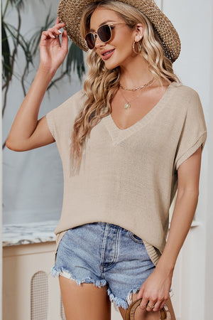 Tan knit tee with V-neck and dolman sleeves, styled with denim shorts.