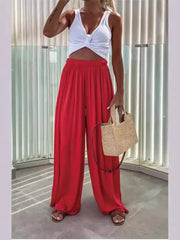Red maternity pants with paperbag waist and wide legs, styled with a white crop top.