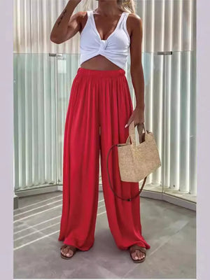 Red maternity pants with paperbag waist and wide legs, styled with a white crop top.