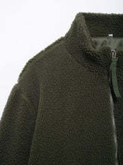 Olive green sherpa jacket with stand collar and zipper detail.