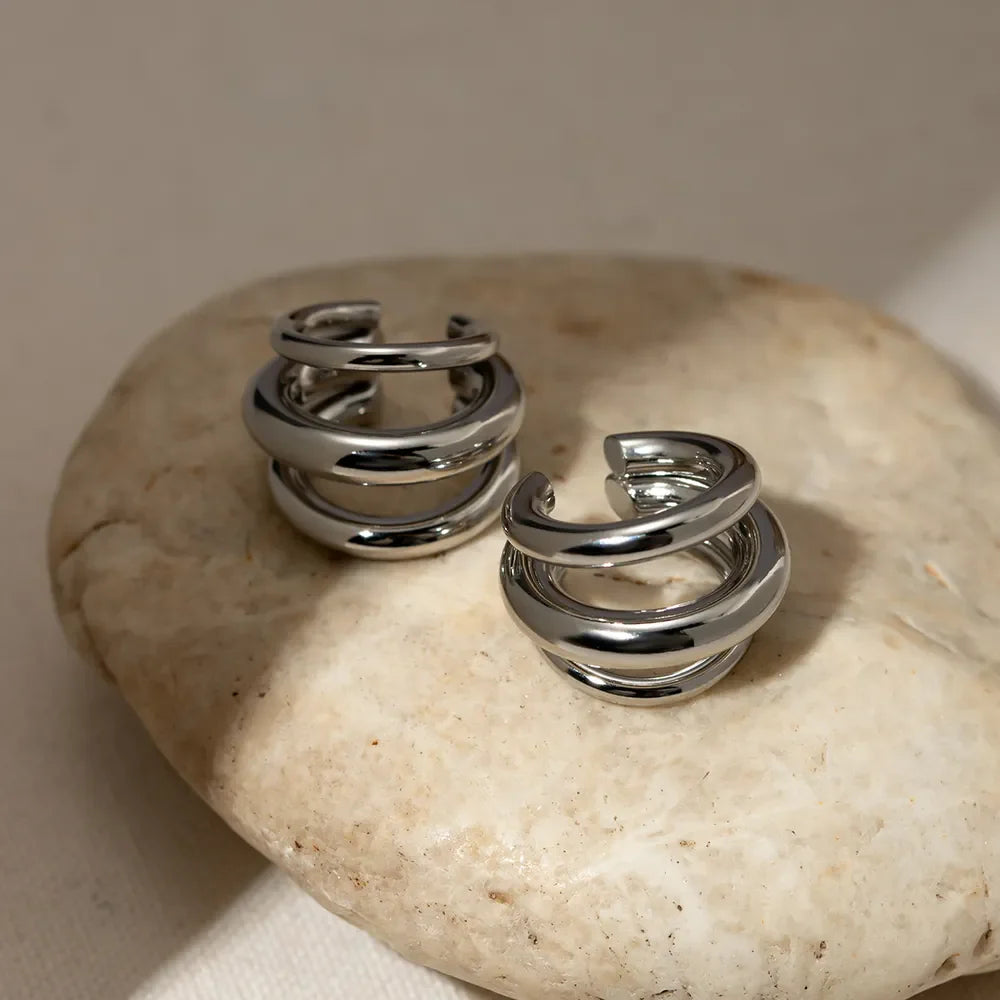 Sculptural silver ear cuff and hoop earrings with layered design