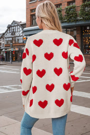 Beige acrylic knit cardigan with allover red heart print, long sleeves, crew neck.