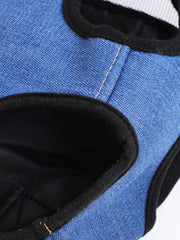 Blue denim pet carrier backpack with black trim and adjustable straps.