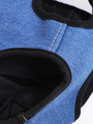 Blue denim pet carrier backpack with black trim and adjustable straps.